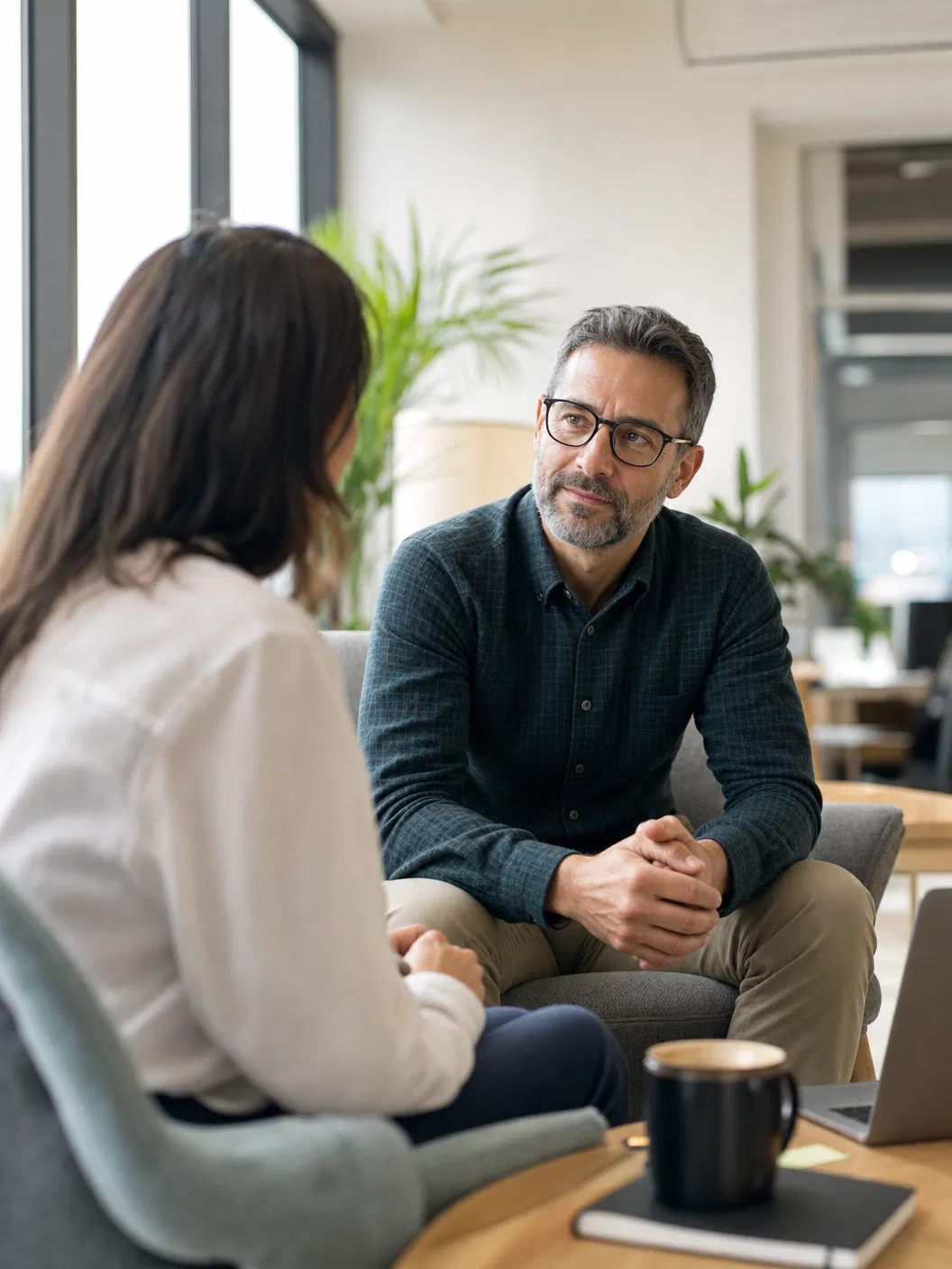 A manager listening to an employee in a supportive one-on-one conversation